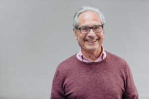 Elderly man smiling confidently after successful Mohs surgery for skin cancer treatment