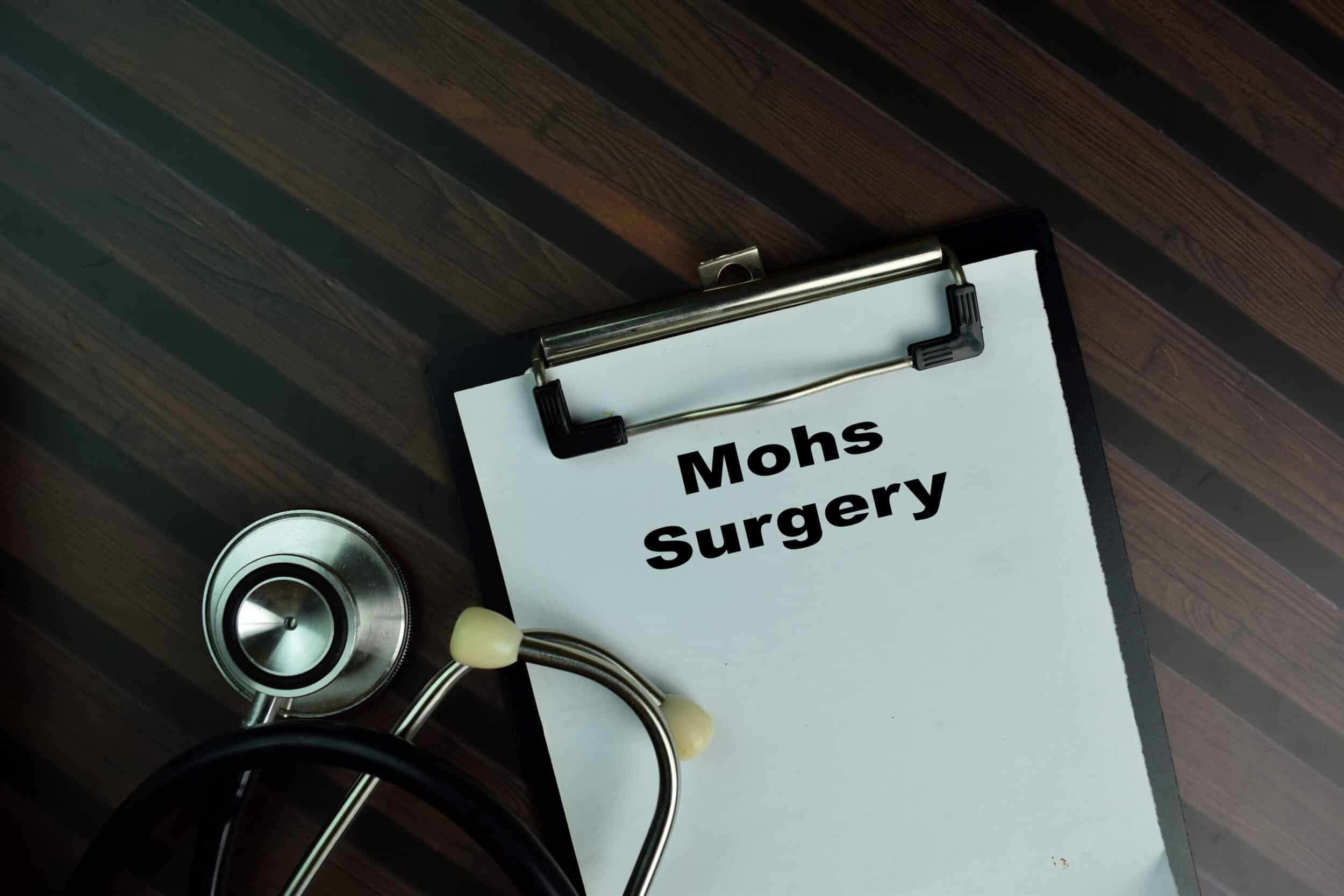 A stethoscope and paper that says "Mohs Surgery" on a table